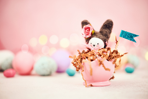 Easter background with cute handmade bunny and eggs.\n*Bunny made by photographer