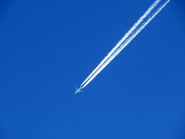 Unusual plane tracks in the blue autumn Swiss sky or conspiracy theory - chemtrails in our heaven (UNESCO World Heritage Tectonic Arena Sardona), Vättis - Switzerland (Schweiz) stock photo