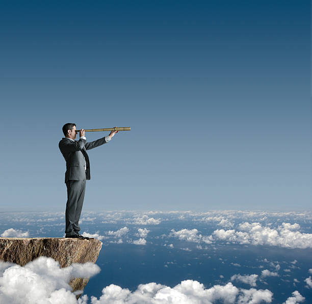 istock Businessman Standing On Cliff Looking Through Spyglass 181954263
