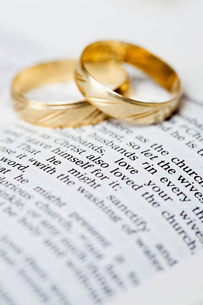 istock Gold wedding bands placed on a King James Version Bible 181954661
