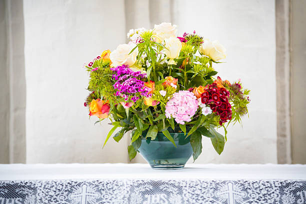 Beautifully arranged bouquet of organic wildflowers serves as a stunning centerpiece on a set party table, adding a touch of natural charm and elegance to the decoration.
