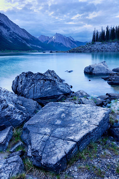 Twilight mountain landscape with Medicine Lake in Canadian Rokies stock photo
