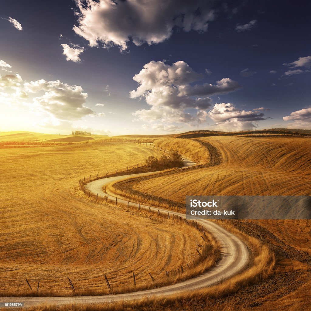 Country Landscape - fields in the sunset sky "Country Landscape - fields and road in the sunset sky. Italy, Tuscany." Wheat Stock Photo