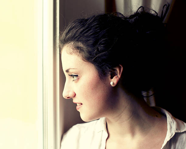 istock Teenage looking through window 181956121