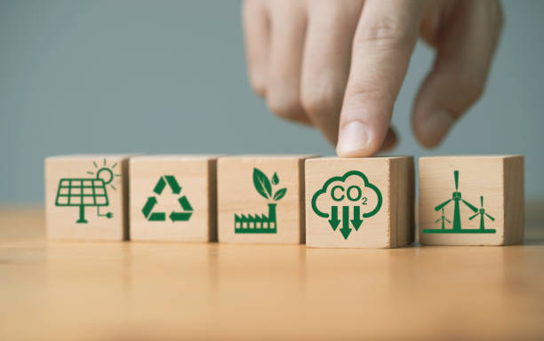 istock Hand pushing carbon reduction icon on wooden block cube among environmental ecology icon include green factory recycle windmill and solar cell for decrease CO2 , carbon footprint and carbon credit. 1819565963