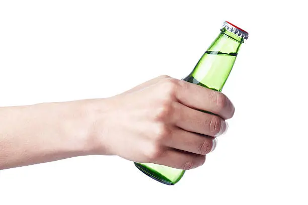 Hand holding a green bottle. Isolated on white background. XXXL