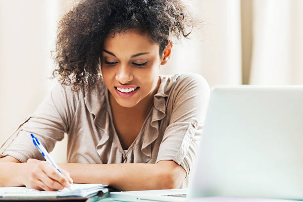 istock Cheerful female student studying at home. 181956847