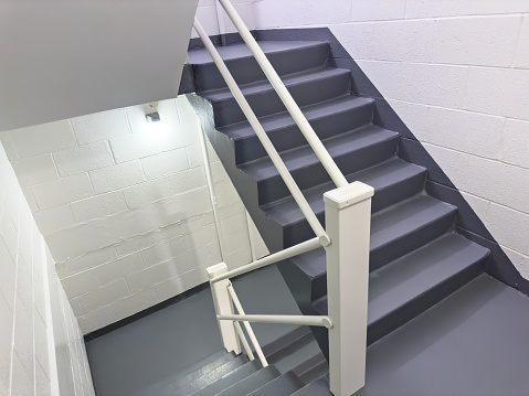 Long metal stair in modern concrete office building.