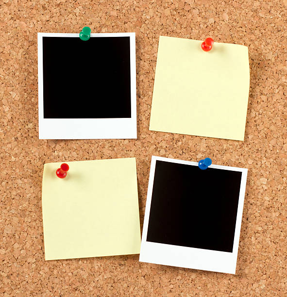 Blank Photo Papers with Post-it on Corkboard Blank Photo Papers with Post-it on Corkboard bulletin board photos stock pictures, royalty-free photos & images