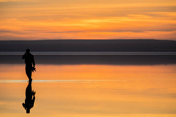 istock Talking under the sunset with mobile phone 181957337