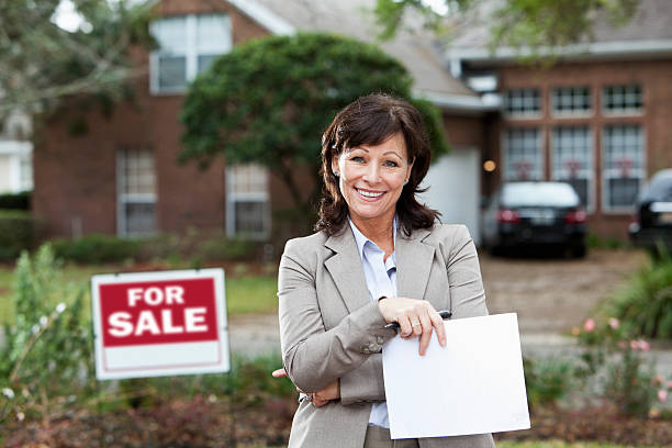 istock Real estate agent standing outside house 181957654