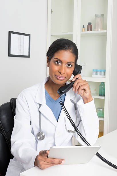 istock Female Doctor Using Telephone 181957825