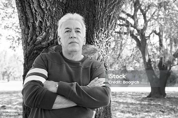 Cuban Man Stands Tall By Florida Tree Stock Photo - Download Image Now - Men, Serious, 50-59 Years