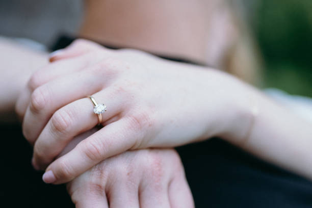 istock Wrapping hands together showing engagement ring 1819581944