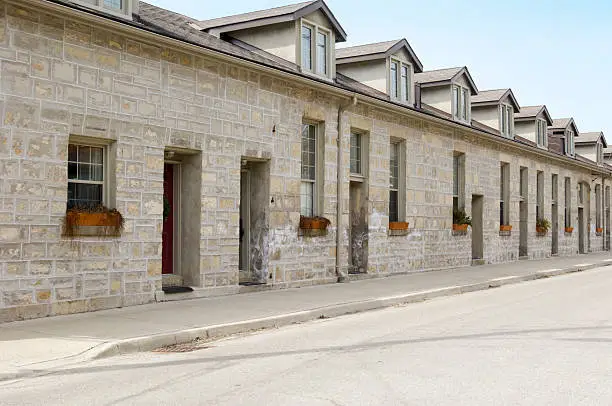 Limestone rowhouses (c. 1860-1890) downtown Guelph in early spring. Neo-classical style.