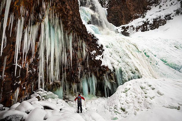 Frozen Waterfall with Icicles on a Cliff stock photo