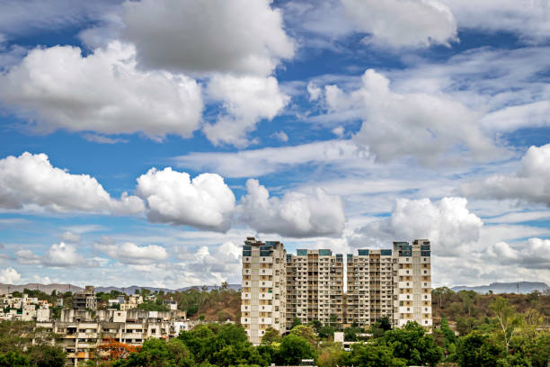 istock Tall residential buildings construction with nice clouds in blue sky background at Pune, Maharashtra. 1819595197