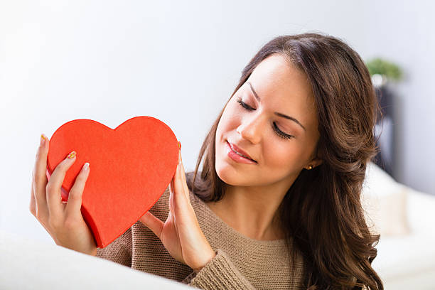 istock Girl holding a red heart-shaped box 181959566