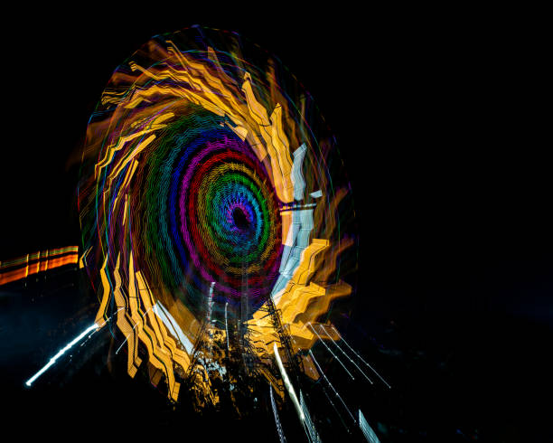 istock Intentional camera movement, slow shutter Zoom blur image of giant Ferris wheel illuminated and spinning at night in a fun fair. 1819596791