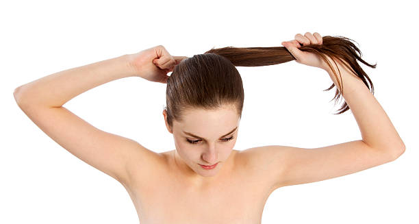 istock Young woman tying her hair 181959888