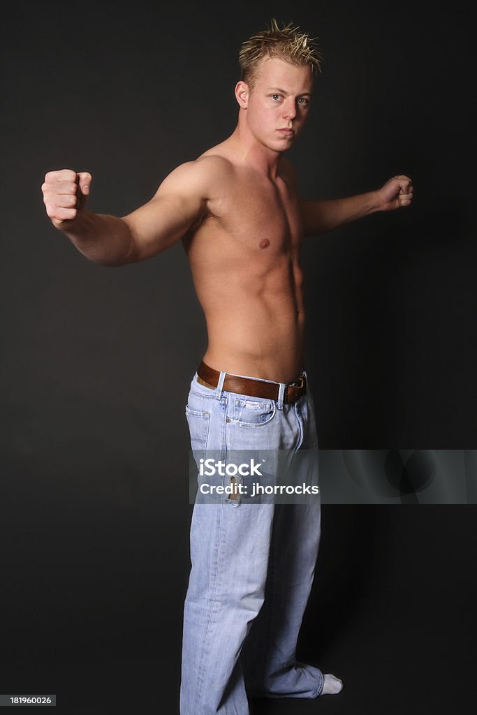 Fit Young Man Strong young man with fists extended outward. 18-19 Years Stock Photo