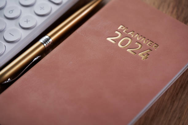 istock 2024 planner and calculator on wooden table 1819651839