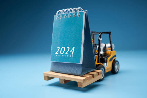 forklif with desk calendar 2024 against blue background