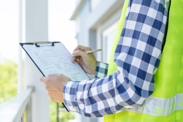 istock inspector or engineer is inspecting construction and quality assurance new house using a checklist. Engineers or architects or contactor work to build the house before handing it over to the homeowner 1819662301