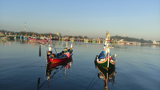 colorful fishing boats anchored in the harbor on Paiton beach Indonesia