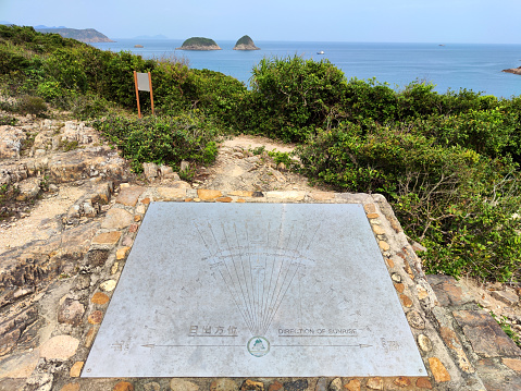 Direction of sunrise sign at Sai Wan Stargazing site in Sai Kung East Country park, Hong Kong.