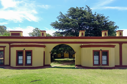 Chascomús, Argentina - Nov 18, 2023: The colonial 1830s main house of the old rural ranch La Alameda on the shore of the Chascomús pond, Buenos Aires Province, Argentina. Copy space