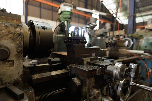 Old big turning lathe at the workshop. Industry factory.
