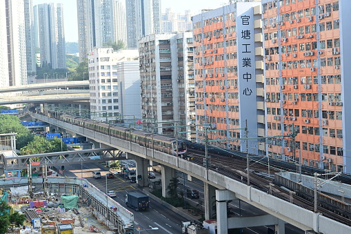 Kwun Tong MTR train and Kwun Tong Industrial architecture, Hong Kong - 11/27/2023 15:10:32 +0000.