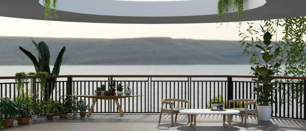 istock A modern spacious balcony with a coffee table, chairs, mini green garden area, and a nature view. 1819760600