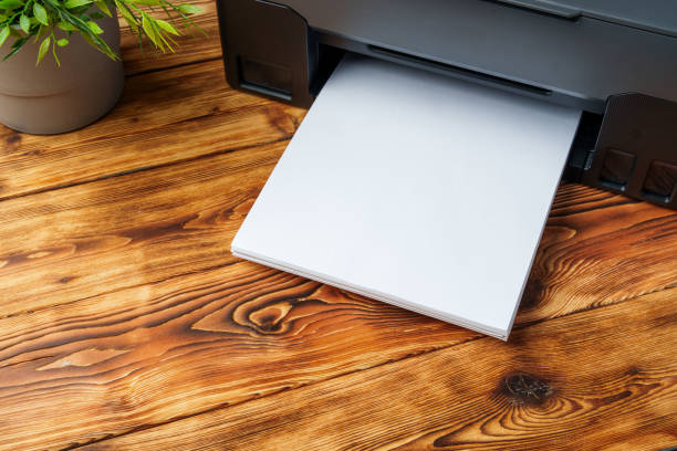 istock Modern laser printer with paper on wooden background 1819761399