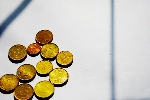 Some shiny one euro cent coins on a pile isolated on a white background.