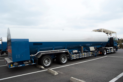 Blank large LNG tanker truck in parking lot.