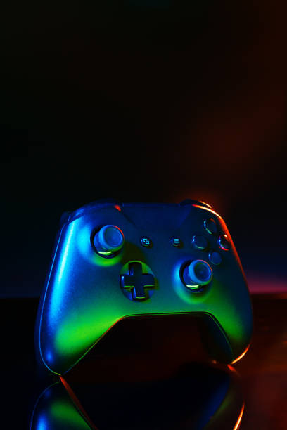 istock Gaming joystick on black background in neon light 1819799844