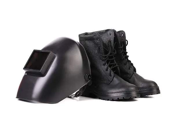 Welding mask and working boots. Isolated on a white background.