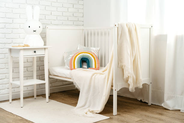 istock Kid's room interior with comfortable bed and rainbow pillow 1819806271