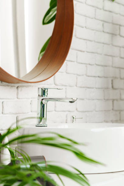 istock Bathroom interior with circle shaped mirror in wooden frame and white sink 1819806272