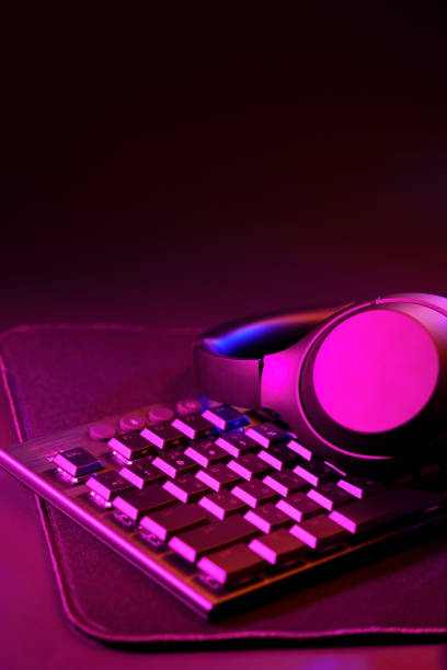 istock Headphones on a computer keyboard on black background 1819806279