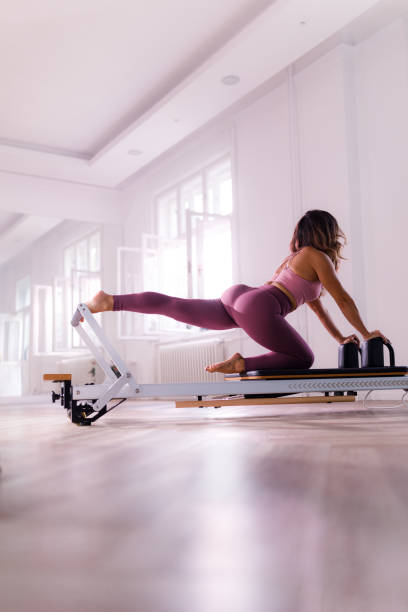 istock Athletic woman stretching on a Pilates machine. 1819808387