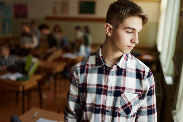istock Thoughtful male students looking through window on a break in the classroom. 1819815168