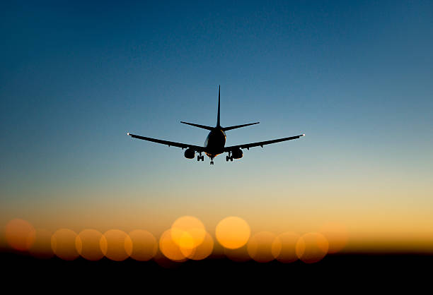 istock aircraft approaching airport at sunset 181981733