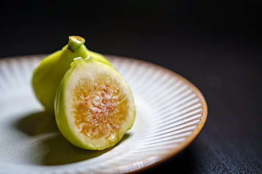 Close up of figs on decorative plate, Still life photography