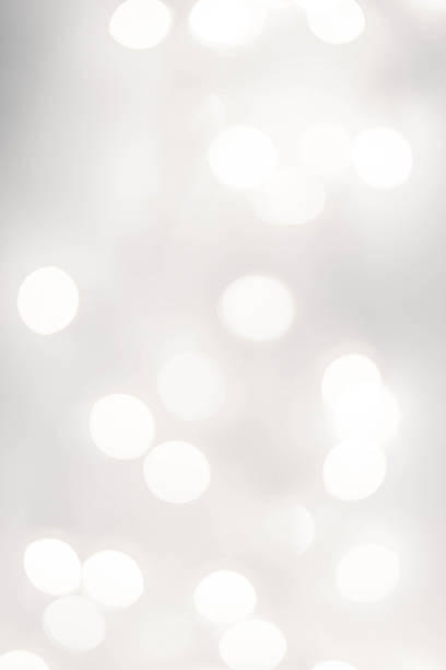 Light silver abstract Christmas background with glowing magic bokeh