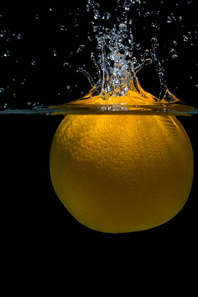 orange with water splash on black