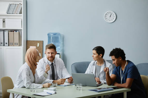 istock Diverse Group of Doctors at Meeting Table Discussing Work Issues 1819837162