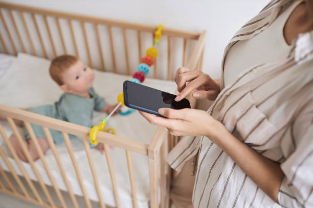 istock Unrecognizable Young Mother Holding Smartphone 1819849715